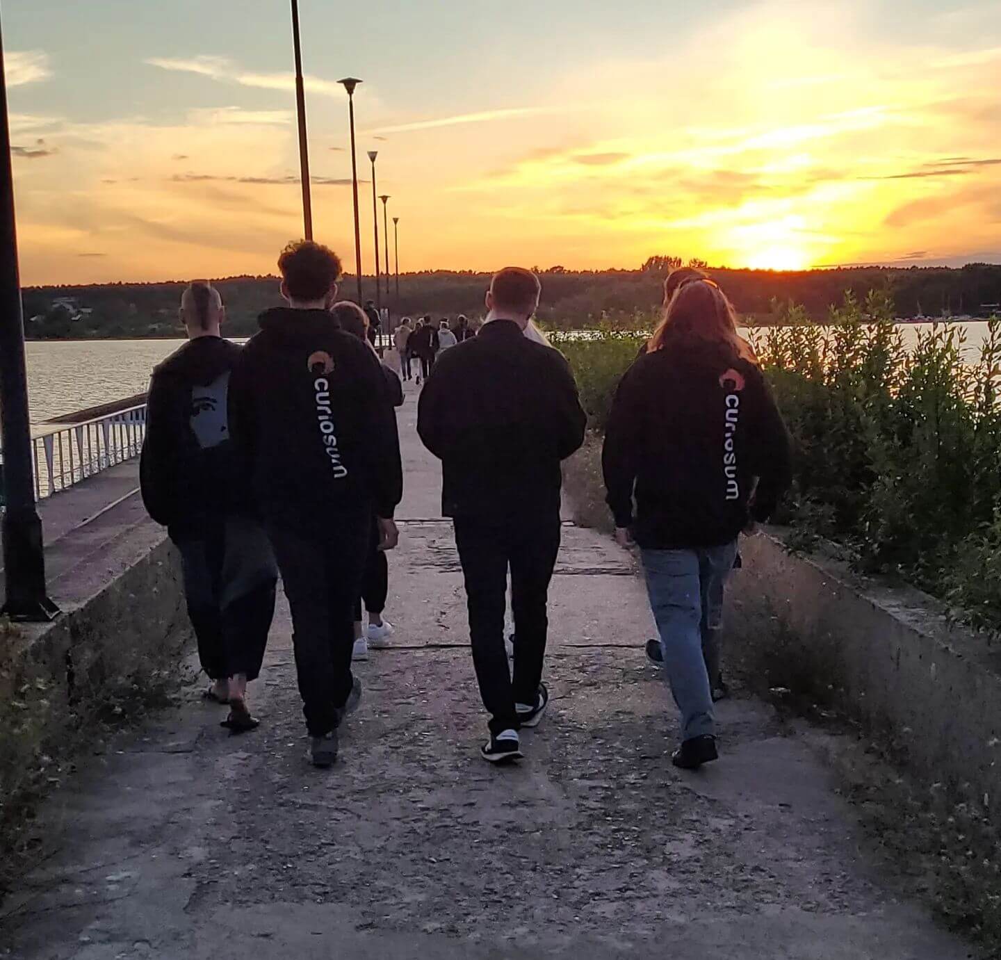 Team members walking towards the sunset